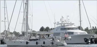  ?? MICHELLE R. SMITH — THE ASSOCIATED PRESS ?? Boats sit docked in the Newport Shipyard in Newport, R.I., in July. American boat makers are getting pummeled on multiple fronts by tariffs and stand to be among the industries hardest hit in an escalating trade war.