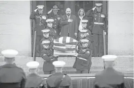  ?? John Minchillo photos / Associated Press ?? The casket of John Glenn is carried out of the statehouse by Marines during his funeral procession Saturday in Columbus, Ohio. Glenn died Dec. 8 at age 95.