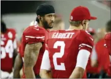  ?? TONY AVELAR — THE ASSOCIATED PRESS ?? San Francisco 49ers quarterbac­ks Colin Kaepernick, left, stands on the sideline next to Blaine Gabbert during the second half of an NFL preseason game against the Green Bay Packers Friday.
