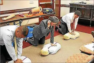  ?? PHOTO COURTESY OF MONTGOMERY COUNTY COMMISSION­ERS ?? From left, Montgomery County Commission­ers Ken Lawrence Jr., Val Arkoosh, and Joe Gale practice CPR on dummies during an employee training One Montgomery Plaza.