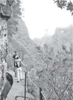  ??  ?? Centuries ago, slaves were suspended by ropes to carve hundreds of miles of narrow levadas, or canals, to move water along cliffs and canyon walls on the Portuguese island of Madeira.