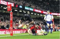  ?? PHOTO: GETTY IMAGES ?? Flyover . . . All Blacks winger Waisake Naholo touches down for a try under pressure from Wales winger Steff Evans during the test at Principali­ty Stadium in Cardiff yesterday.