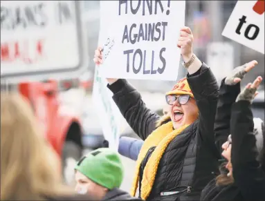  ?? Matthew Brown / Hearst Connecticu­t Media ?? Hilary Gunn of Greenwich joins with approximat­ely 100 activists from a anti-toll group No Tolls CT, as they stage a protest in front of the Government Center on Saturday in Stamford.