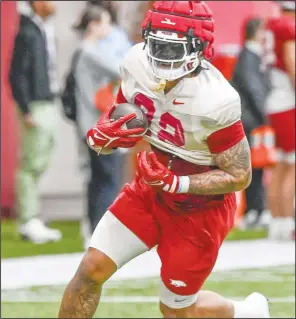  ?? Craven whitlow / Special to the Saline courier ?? Razorback senior running back Ja’quinden Jackson (#2) from Dallas, Texas, runs through a drill during practice inside the Willard & Pat Walker Pavilion in Fayettevil­le on Tuesday.