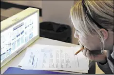  ?? AP 2009 ?? Dental hygienist Heather Heathcote takes an exam while studying to become a dental therapist at Normandale College in Edina, Minn. Several states, including Ohio, Texas and Kansas, are considerin­g bills that create a new midlevel position called dental therapists.