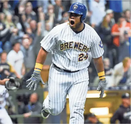  ??  ?? Jesus Aguilar reacts after hitting a walk-off home run in the ninth inning against Miami.