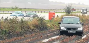  ??  ?? Above — stranded cars between Ardestie and Ethiebeato­n, as well as another stuck in a field. Left — firefighte­rs pumping water out of a house at Balmossie Mill, Barnhill.