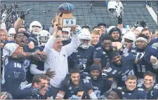  ?? PETE BANNAN – MEDIANEWS GROUP ?? Villanova coach Mark Ferrante holds up the Battle of the Blue trophy after the Wildcats knocked off Delaware last season. If the annual game between the Wildcats and the Blue Hens is to be played again, it won’t be until at least the spring of 2021.