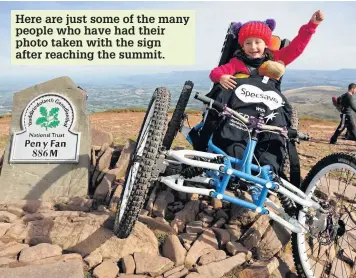  ?? DIMITRIS LEGAKIS ?? Imogen Ashwell Lewis in a prototype four wheeled mountain bike. Soldiers from the Battle School in Brecon as well as friends and colleagues of the organisers helped to pull the bike to Pen y Fan in a walk sponsored by Specsavers Wales for charity Cerebra Here are just some of the many people who have had their photo taken with the sign after reaching the summit.