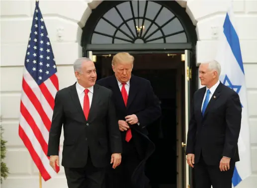  ?? (Carlos Barria/Reuters) ?? US PRESIDENT Donald Trump adjusts his jacket as he welcomes Prime Minister Benjamin Netanyahu with Vice President Mike Pence at the White House last month. Trump has dispelled any vestige of Palestinia­n trust in American intentions.