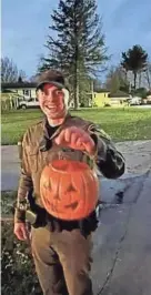  ?? PROVIDED BY GRETCHEN WORLEY ?? Conservati­on officer Alex Toth holds the plastic pumpkin that became stuck to a deer’s face for about two weeks just outside LaPorte. He and farm animal veterinari­an Dr. Larry Smith removed it Friday from the doe’s head.