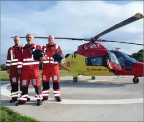  ??  ?? Captain John Murray (centre) with crew members Paul Traynor and Brian O’Callaghan pictured with Irish Community Rapid Response (ICRR) charity air ambulance at Rathcoole Aerodrome.