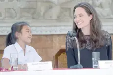  ?? — AFP ?? Hollywood star Angelina Jolie with with Cambodian child actress Sareum Srey Moch during a press conference at a hotel in Siem Reap on Saturday.
