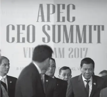  ?? (AP) ?? VIETNAM. Philippine President Rodrigo Duterte, right, leaves the Asia-Pacific Economic Cooperatio­n (Apec) CEO Summit in Danang, Vietnam, Thursday, Nov. 9, 2017.