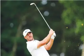  ?? The Associated Press ?? ■ Brooks Koepka watches his shot on the 11th hole during the second round of the U.S. Open at The Country Club June 17 in Brookline, Mass.