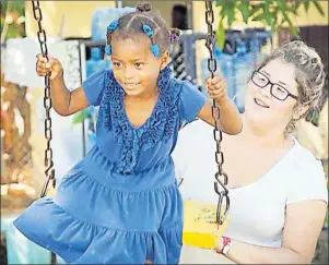  ?? SUBMITTED PHOTO ?? Kendra Gould, right, is shown pushing Perla Lopez on a swing when Gould was in the Dominican Republic earlier in the school year, helping to rebuild the child’s home. For this and her other community work, the 17-year-old Eskasoni student has been...