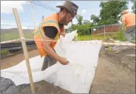  ??  ?? A scientist digs for rare artifacts in East Norwalk as part of a $1 million archaeolog­ical excavation underway in Norwalk