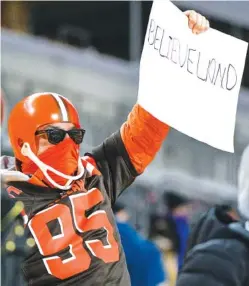  ?? AP PHOTO/DON WRIGHT ?? A Cleveland fan holds a sign after the Browns’ wild-card playoff game victory over the Pittsburgh Steelers last Sunday in Pittsburgh.
