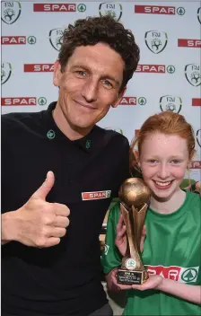  ??  ?? Keith Andrews presents the Player of the Tournament Section A trophy to Ciara Brennan, from Drimina NS.