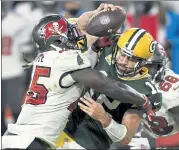  ?? AP ?? Buccaneers inside linebacker Devin White, left, sacks Green Bay Packers quarterbac­k Aaron Rodgers during the second half on Sunday.