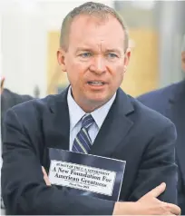  ?? MARK WILSON, GETTY IMAGES ?? Office of Management and Budget Director Mick Mulvaney, holds a copy of President Trump’s 2018 budget.