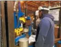  ?? DONNA ROVINS — DIGITAL FIRST MEDIA ?? Pottstown-based American Keg recently laid off one-third of its workforce due to increased prices for U.S. steel. The company is urging tariffs be imposed on imported kegs to level the playing field. Shown here — Jared Wilson works at a machine that...