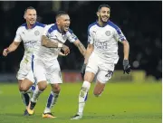  ?? Picture: GETTY IMAGES ?? JUBILATION: Riyad Mahrez, right, of Leicester City celebrates scoring his team’s goal with his teammates Danny Drinkwater, left, and Danny Simpson