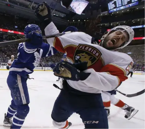  ?? RICK MADONIK/TORONTO STAR ?? Panthers defenseman Jason Demers is high-sticked by Leafs centre William Nylander during the frantic third period at the ACC on Tuesday.