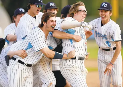  ?? STEPHEN M. KATZ/STAFF ?? First Colonial baseball players celebrate a victory over Cox on Friday after scoring three runs in the bottom of the seventh inning.