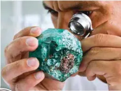  ??  ?? (Clockwise from left)
A worker looks at an emerald at Muzo Emerald Co’s workshop in Bogota.
Colombian emeralds are considered the most beautiful in the world.
Ronald Ringsrud shows emeralds during an interview.
