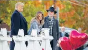  ?? AFP ?? Trump and Melania pay respect to the synagogue attack victims.