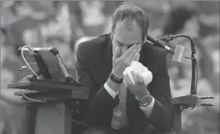  ?? PHOTOS BY JUSTIN TANG, THE CANADIAN PRESS ?? Umpire Arnaud Gabas of France holds his face after being hit by a ball during a Davis Cup match Sunday that resulted in the disqualifi­cation of Canadian Denis Shapovalov, left.