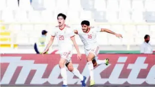  ??  ?? Iran’s Sardar Azmoun (left) celebrates after second a goal against Vietnam during their match in Abu Dhabi.