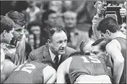  ?? AP ?? Gene Hackman gives fictional Hickory High basketball players instructio­ns during filming of the final game of “Hoosiers” at Hinkle Fieldhouse on the Butler University campus in Indianapol­is. “Hoosiers” was No. 1 in The Associated Press Top 25 of best sports movies.