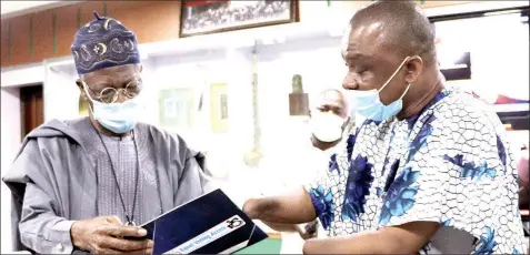  ??  ?? Minister of Informatio­n and Culture, Lai Mohammed ( left) and Executive Director, Centre for Citizens with Disabiliti­es, David Anyaele, during a courtesy visit and presentati­on of some publicatio­ns by the Centre to the minister in Abuja… yesterday. PHOTO: NAN