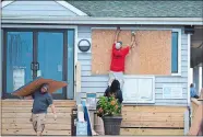  ?? MATT BORN/THE STAR-NEWS VIA AP ?? Crews board up the Oceanic restaurant in Wrightsvil­le Beach, N.C., on Tuesday in preparatio­n for Florence.