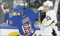  ??  ?? Sidney Crosby engages the Rangers’ Rick Nash along the boards Friday night.