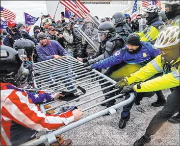  ?? The Associated Press ?? Jose Luis Magana
Rioters struggle with police officers outside the U.S. Capitol on Jan. 6, 2021, following President Donald Trump’s disputed loss to challenger Joe Biden in the 2020 election.