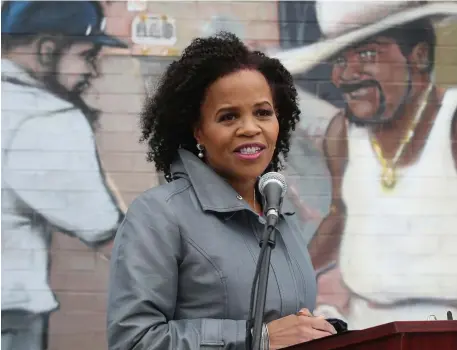  ?? NAncy lAne pHotos / HerAld stAff ?? ‘WE’VE GOT WORK TO DO’: Acting Mayor Kim Janey announces the launch of her campaign for mayor of Boston during a press conference in front of the Faces of Dudley mural in Nubian Square on Tuesday. Below left, Janey bumps elbows with the Rev. Miniard Culpepper after her announceme­nt.