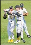  ?? ?? Pittsburgh Pirates outfielder­s Ben Gamel (left), Jack Suwinski (65) and Bryan Reynolds celebrate after getting the final out of a baseball game against the Los Angeles Dodgers in Pittsburgh. The Pirates won 5-3. (AP)