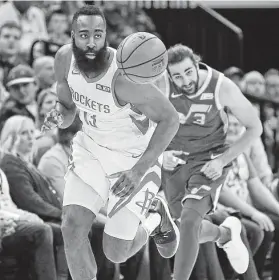  ?? Rick Bowmer / Associated Press ?? James Harden and Jazz guard Ricky Rubio follow the bouncing ball Saturday night in Salt Lake City. Harden has scored at least 30 points in the past 26 games.