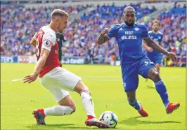  ??  ?? Arsenal’s midfielder Ramsey (L) vies with Cardiff City’s Hoilett during the English Premier League match