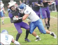  ?? Photo by Ernest A. Brown ?? Cumberland junior linebacker Phil Coppolino (51) looks to bring down St. Raphael running back Andre Gray (8) during first-quarter action at Pariseau Field Saturday.