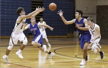  ?? The Maui News / MATTHEW THAYER photos ?? PHOTO ABOVE: St. Anthony’s Evan Essner (left) and Seabury Hall’s Kama Konohia compete for a second-quarter loose ball Friday. PHOTO BELOW: The Spartans’ Noah Payne follows through on a second-quarter shot.