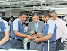  ??  ?? Factory officials explaining a point to the Ambassador