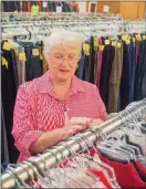  ??  ?? Nita Ketchum, a volunteer, sorts through clothing at the Cleburne County Cares retail store in Heber Springs. Bobby Hargis, director, said the nonprofit’s retail store funds 90 percent of the programs CCC offers, including its food pantry.