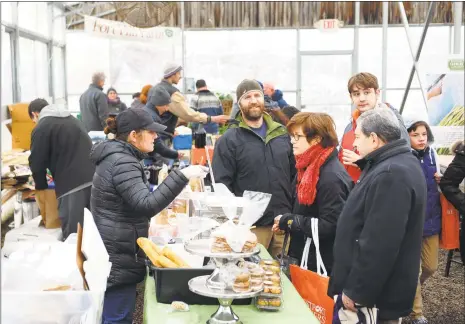  ?? Christian Abraham / Hearst Connecticu­t Media ?? With a new “cottage food” law in effect, Connecticu­t residents can legally sell nonperisha­ble foods prepared and packaged in their home kitchens, though distributi­on is limited to direct delivery or farmers markets such as the Westport Winter Farmers Market, seen here.