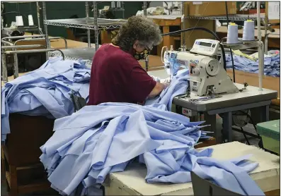  ?? (Republican-Herald/Jacqueline Dormer) ?? Marlene Long of Shamokin, Pa., sews a U.S. Postal Service shirt last month during the official opening of Brigade Manufactur­ing North LLC in Ashland, Pa. The Institute for Supply Management reported Monday that its manufactur­ing index rose by 3.9 percentage points in October.