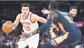  ?? Mary Altaffer / Associated Press ?? New York Knicks forward Kevin Knox (20) drives to the basket against New Orleans Pelicans forward Cheick Diallo during a preseason game on Friday at Madison Square Garden.