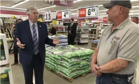  ?? Photograph: David A Lieb/AP ?? Missouri Governor Mike Parson, left, visits a hardware store in May.